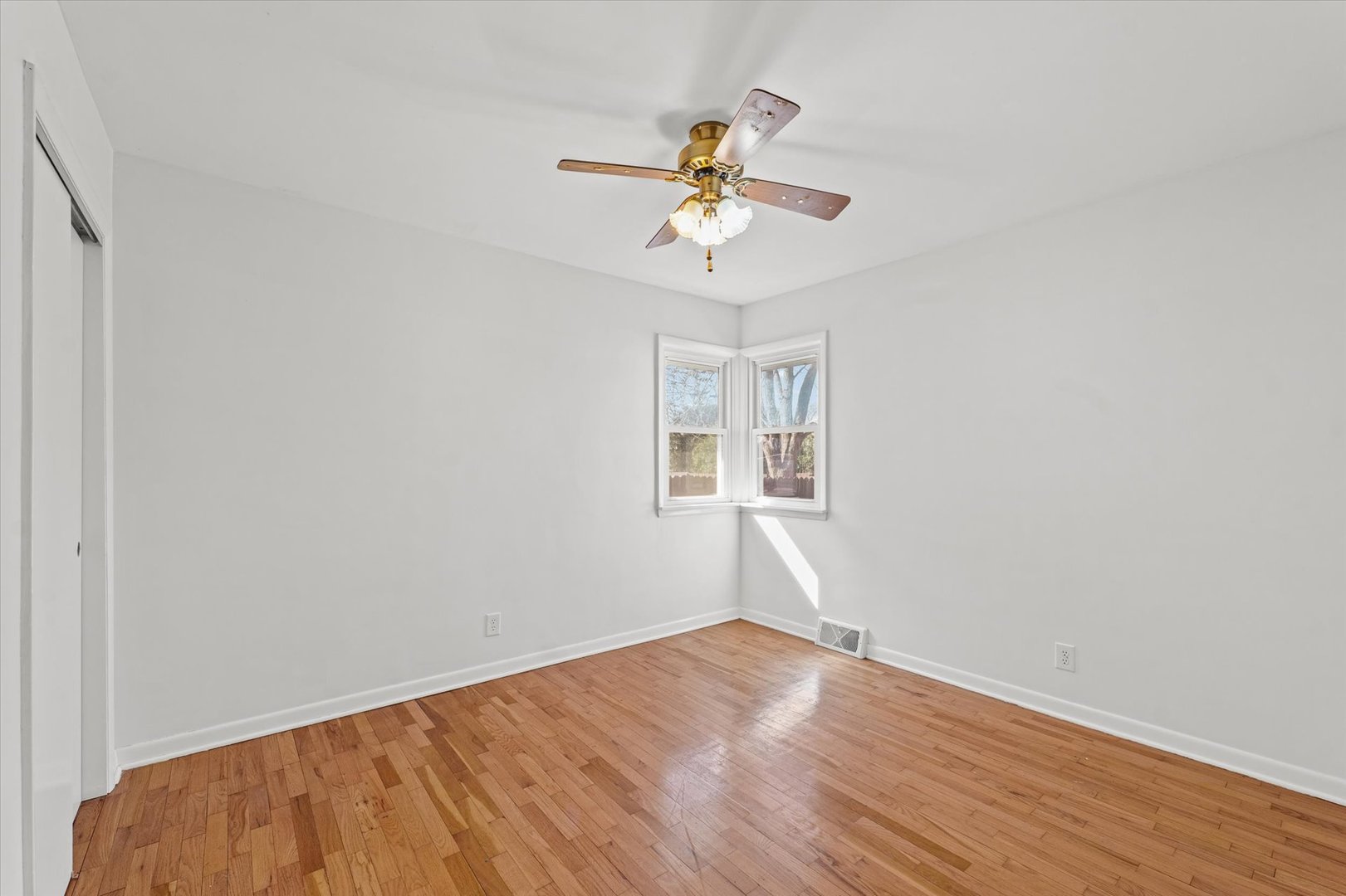 404 South Maple Street Gilman, IL 60938 - Photo 17 of 28 a view of a room with wooden floor and windows