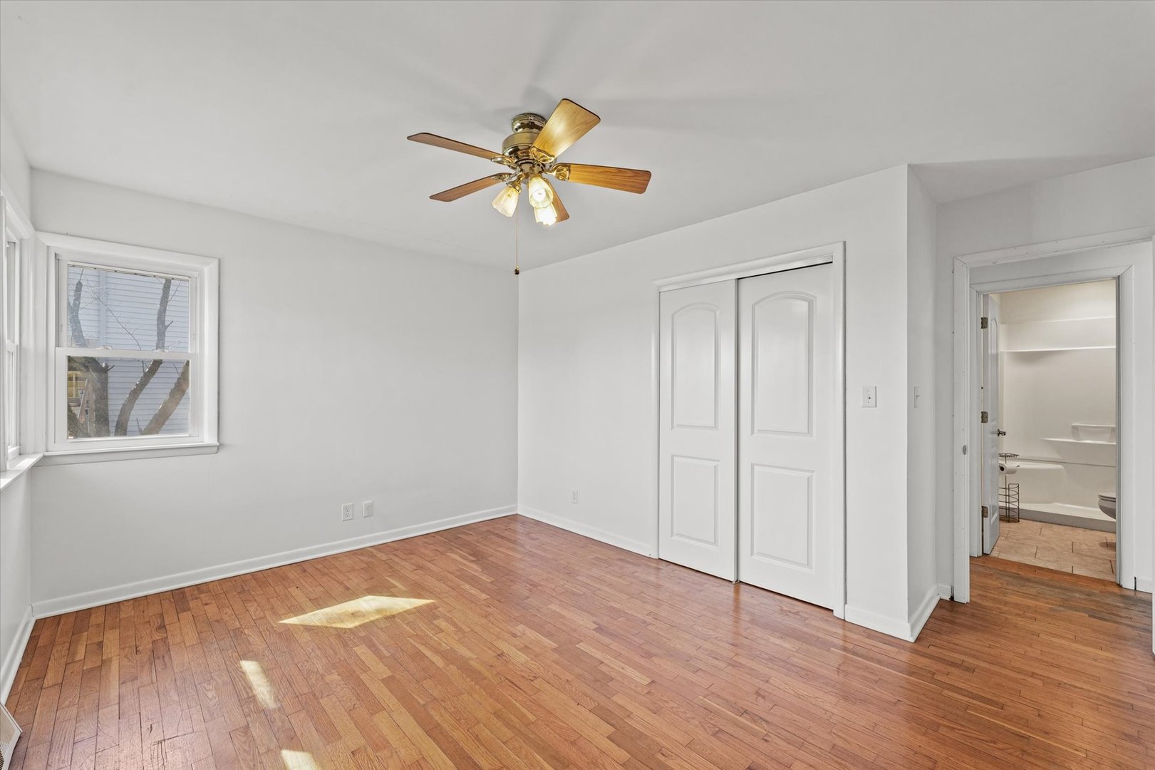 404 South Maple Street Gilman, IL 60938 - Photo 20 of 28 a view of empty room with wooden floor and fan