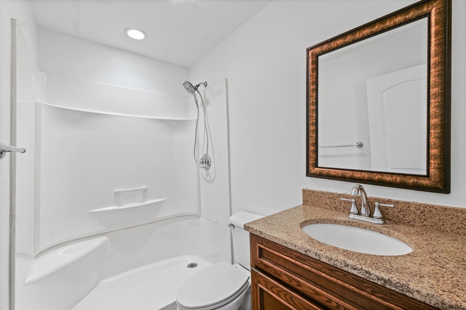 404 South Maple Street Gilman, IL 60938 - Photo 21 of 28 a bathroom with a granite countertop sink a toilet and a mirror