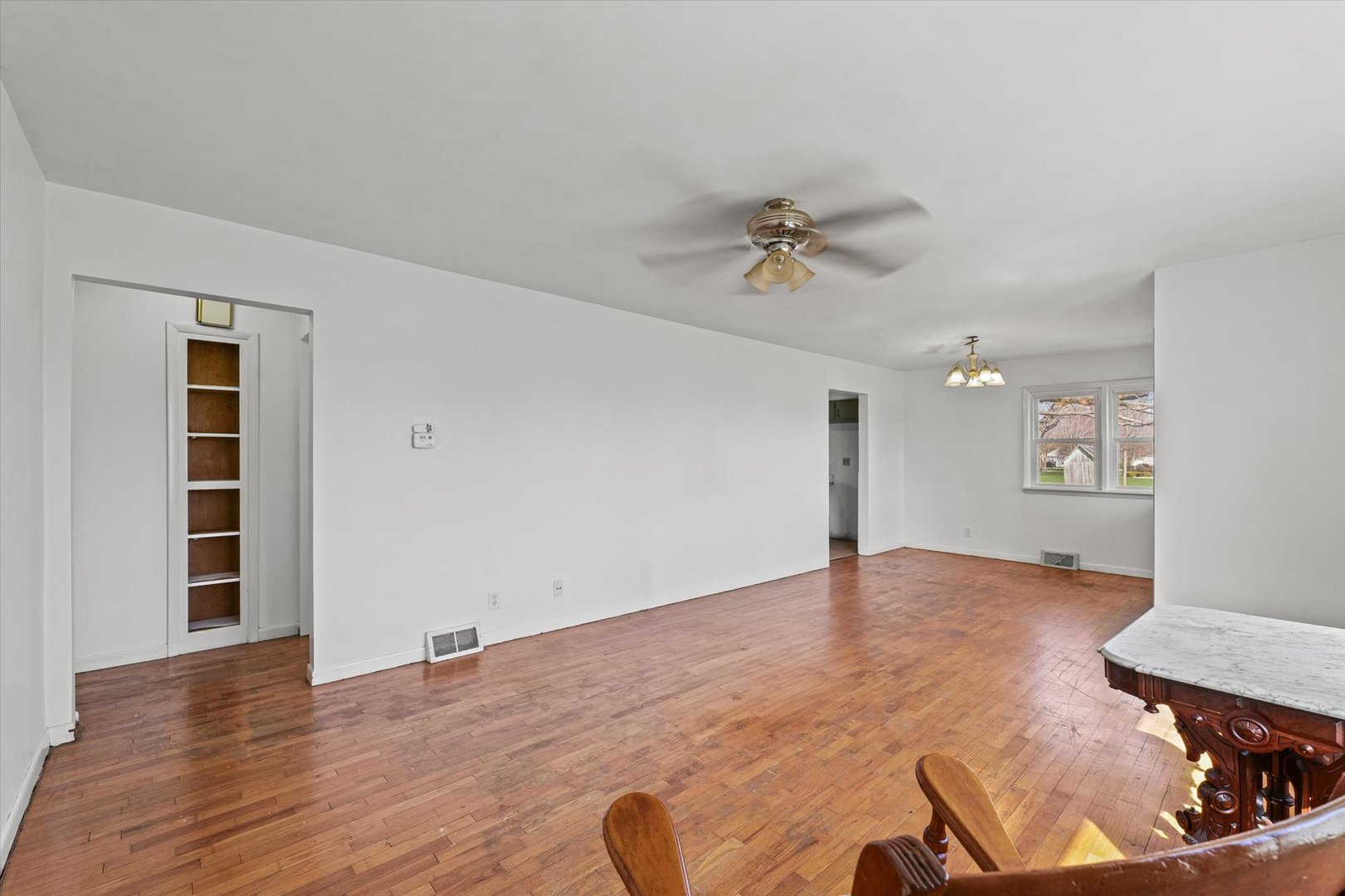 404 South Maple Street Gilman, IL 60938 - Photo 8 of 28 wooden floor in an empty room with a window