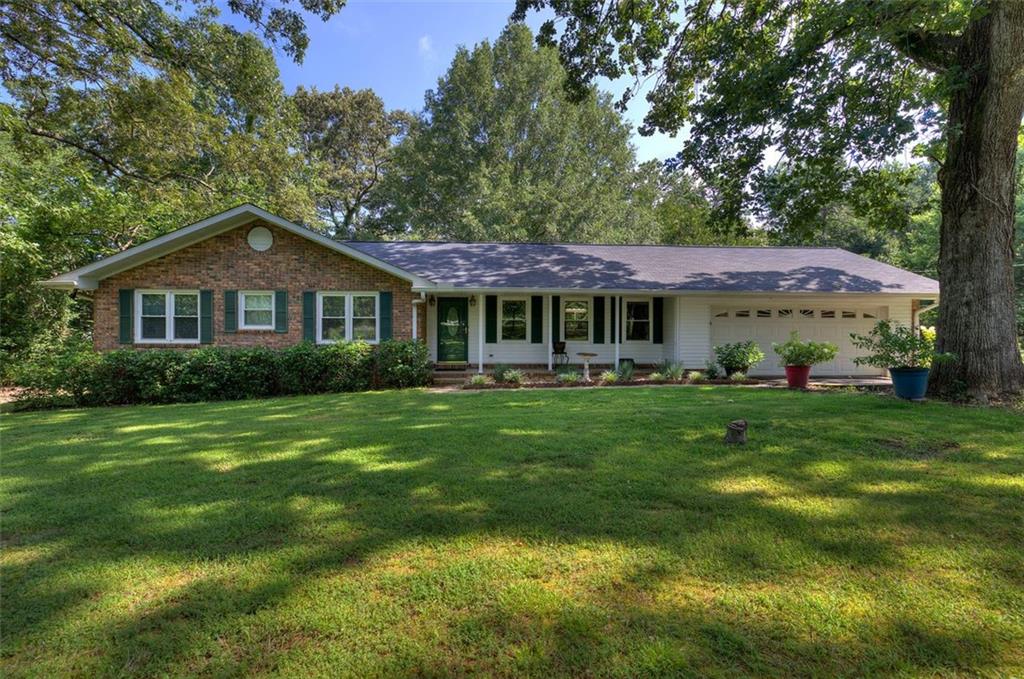 1124 Boone Ford Road Southeast Calhoun, GA 30701 - Photo 1 of 1 a front view of a house with a garden