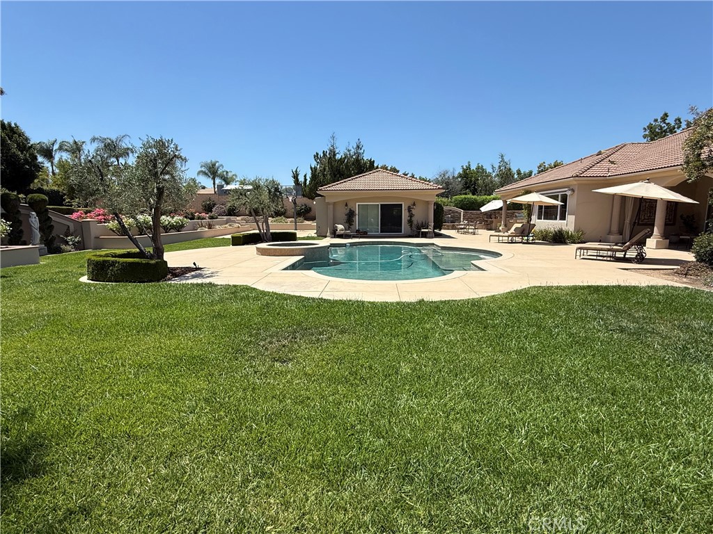 1662 Cherokee Road Corona, CA 92881 - Photo 5 of 60 a view of a house with swimming pool and sitting area
