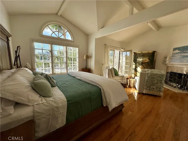 a spacious bedroom with a bed and a large window