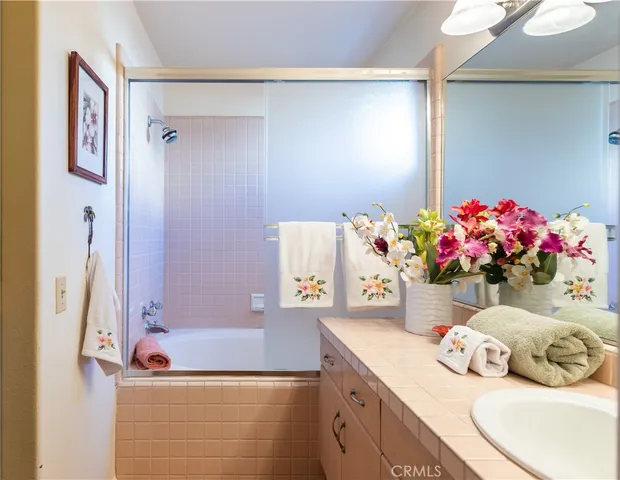 a bathroom with a sink mirror and vanity