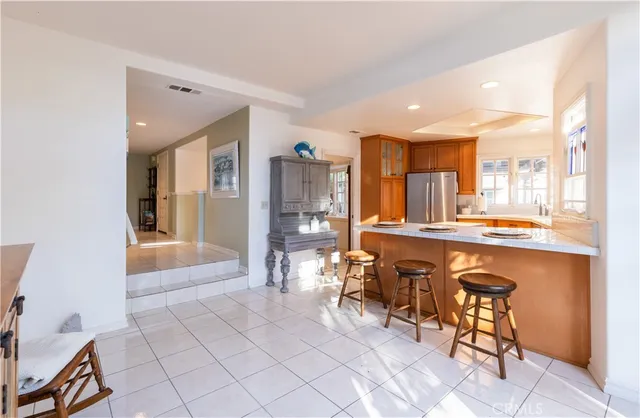 a very nice looking dining room with kitchen island granite countertop a table and chairs in it