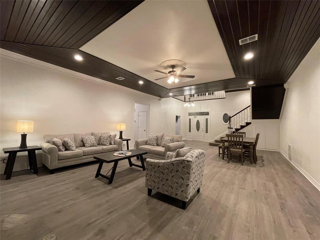 865 Higgins Road Sherman, TX 75092 - Photo 11 of 40 a living room with furniture and a chandelier