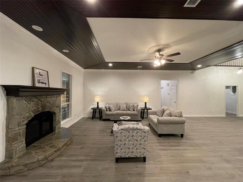 865 Higgins Road Sherman, TX 75092 - Photo 12 of 40 a living room with furniture and a fireplace