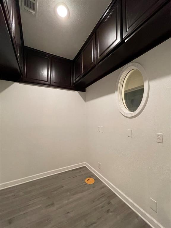 865 Higgins Road Sherman, TX 75092 - Photo 16 of 40 a view of an empty room with wooden floor and cabinets