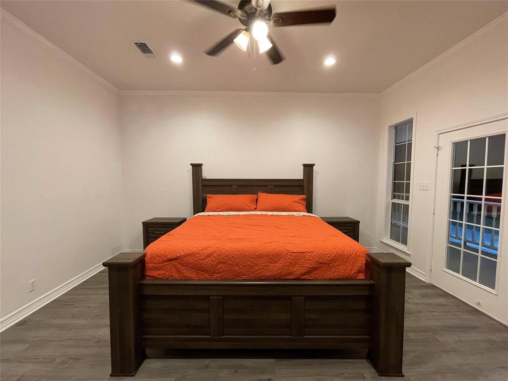 865 Higgins Road Sherman, TX 75092 - Photo 18 of 40 a bed sitting in a bedroom next to a window with bookshelf