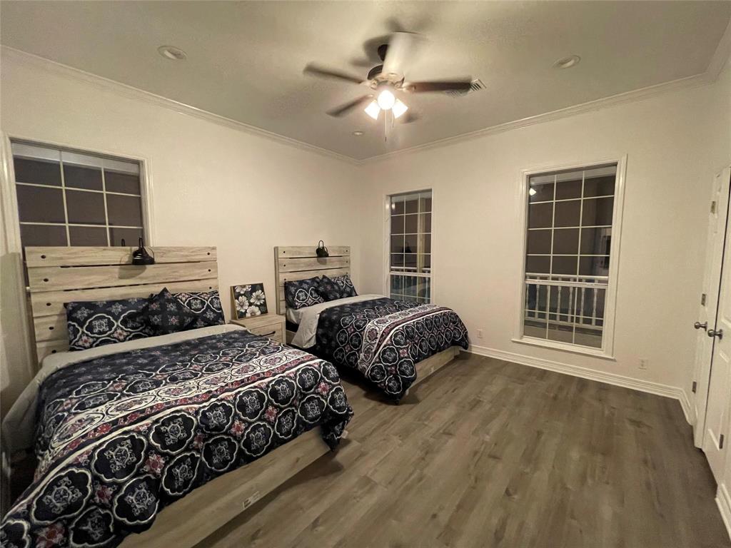 865 Higgins Road Sherman, TX 75092 - Photo 24 of 40 a bedroom with two large bed and a window