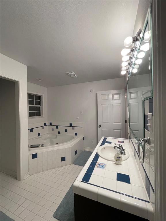 865 Higgins Road Sherman, TX 75092 - Photo 32 of 40 a bathroom with a sink a vanity and a mirror