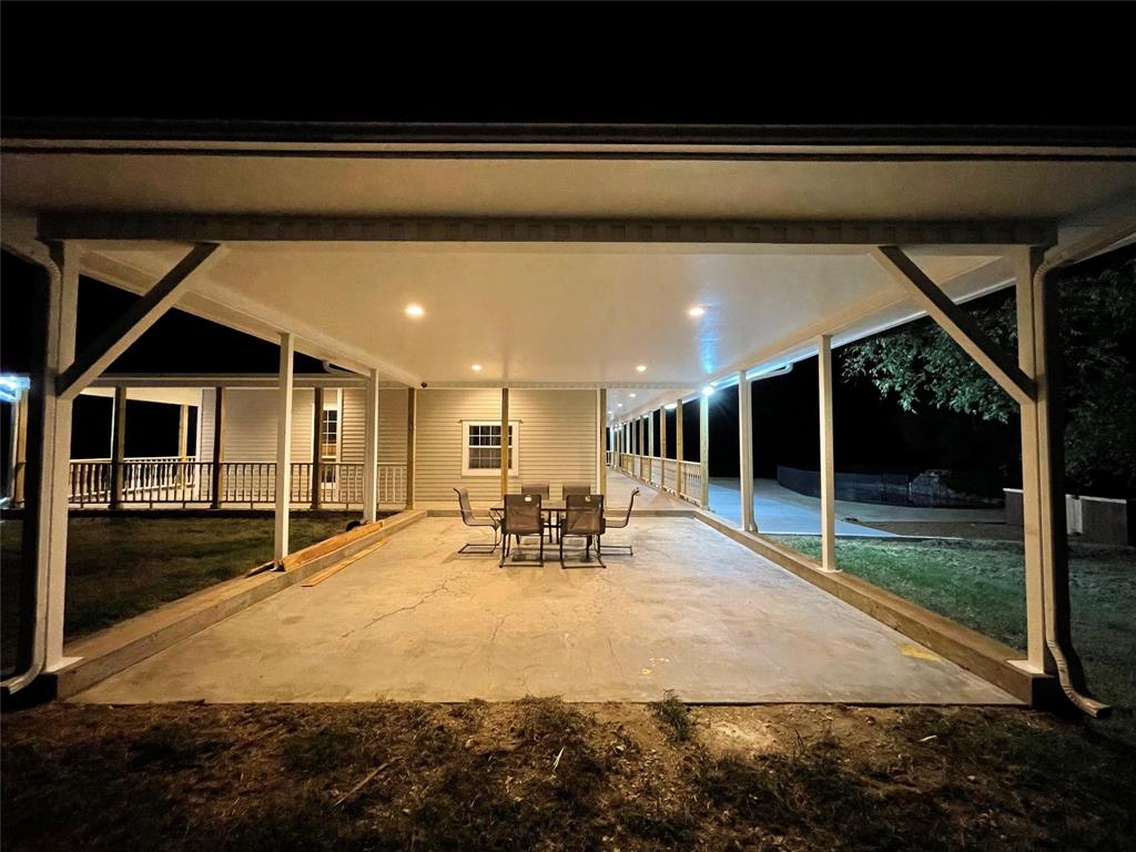865 Higgins Road Sherman, TX 75092 - Photo 35 of 40 a view of a patio with table and chairs with wooden floor and fence