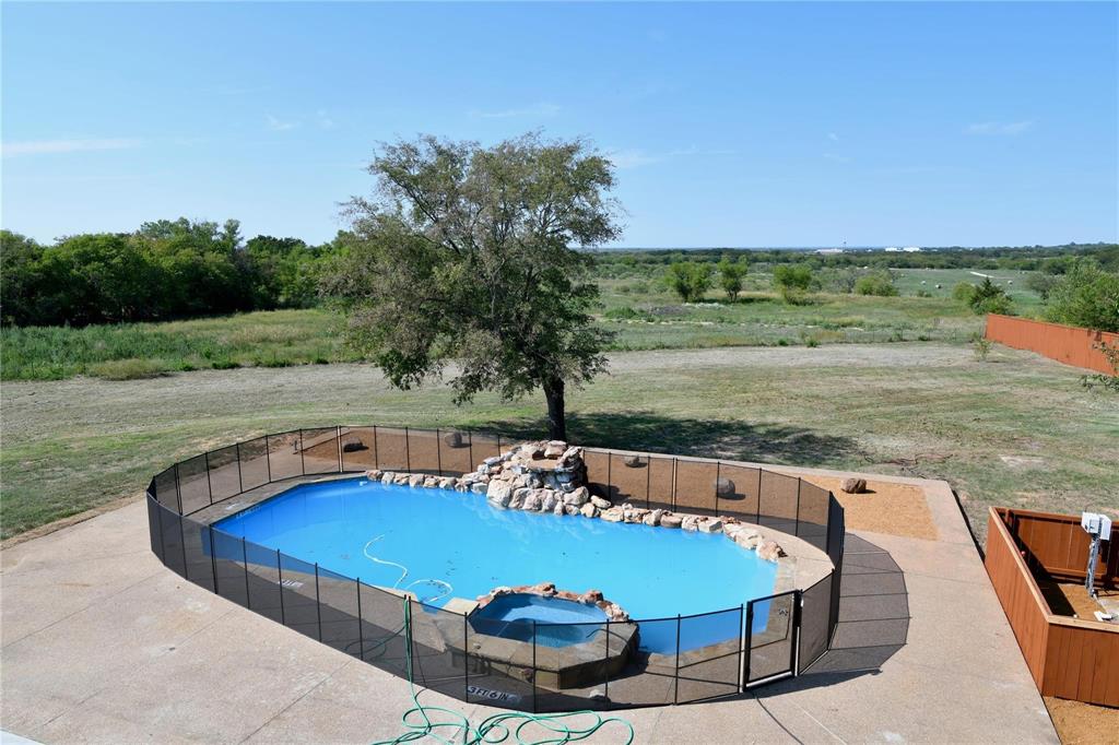 865 Higgins Road Sherman, TX 75092 - Photo 6 of 40 a view of a swimming pool with lawn chairs