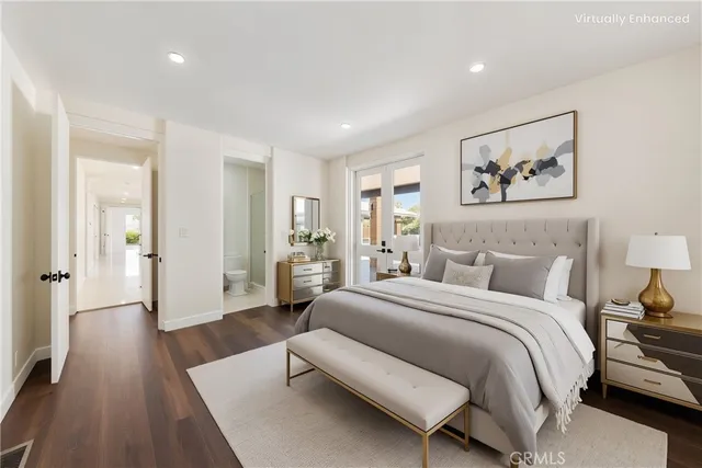 a spacious bedroom with a bed and wooden floor