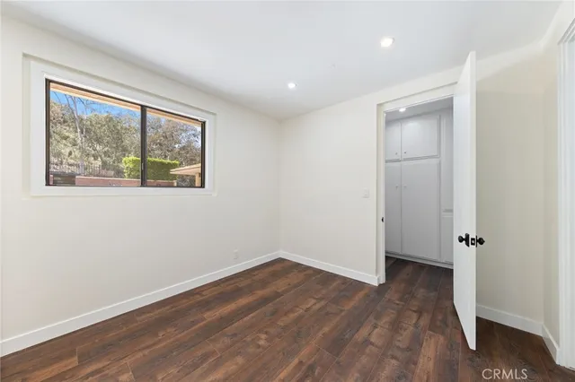 a view of a room with wooden floor and window