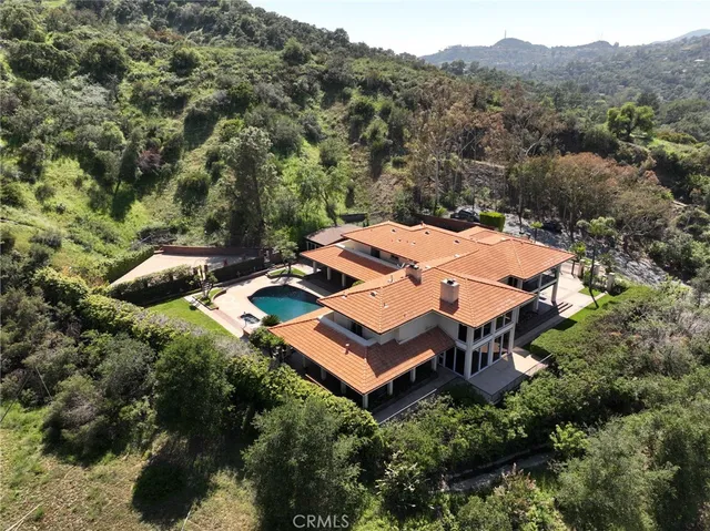 an aerial view of a house with a yard