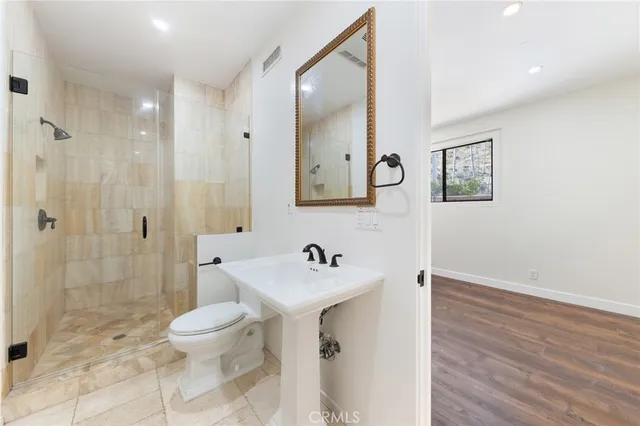 a bathroom with a sink toilet and shower