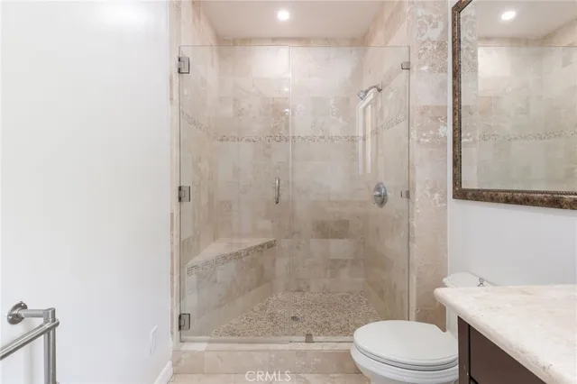 a bathroom with a shower a toilet and sink