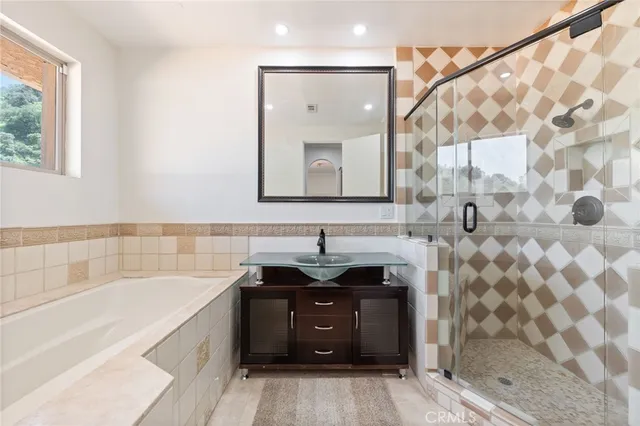a bathroom with a sink a bathtub and a mirror