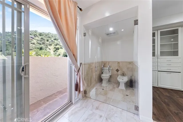a bathroom with a granite countertop sink and a shower