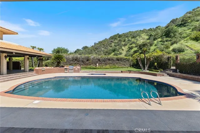 a view of a swimming pool with a yard