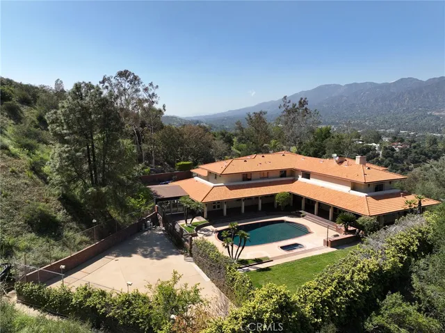 an aerial view of a house with a yard