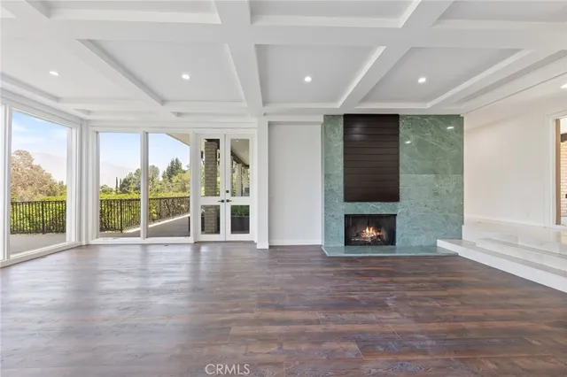 a view of an empty room with a fireplace and a window