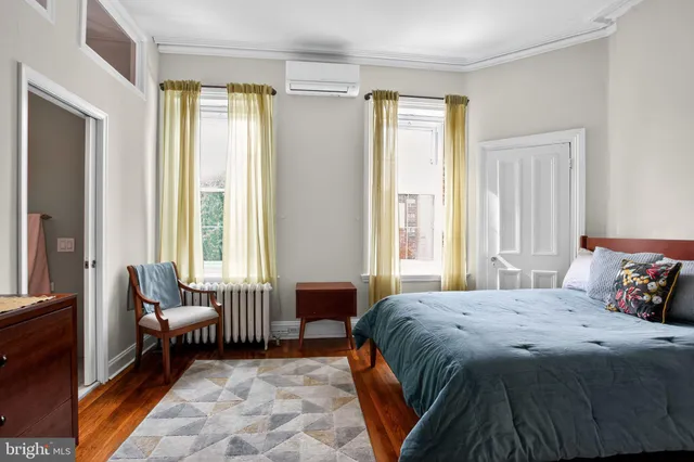 a bedroom with a bed and a couch