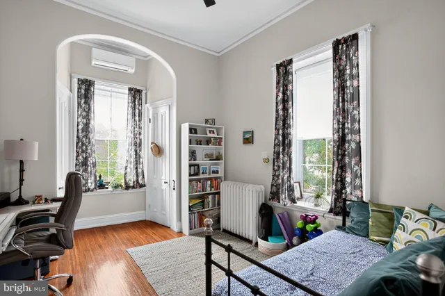 a bedroom with furniture and a window