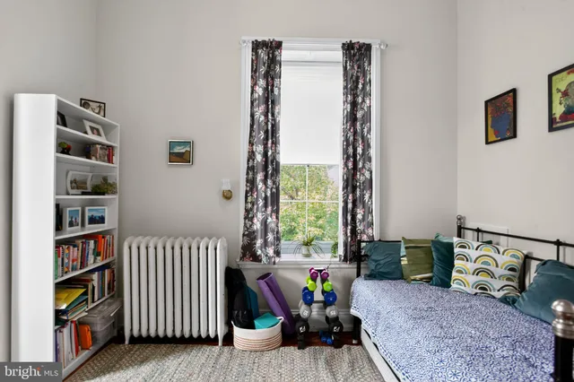 a view of a livingroom with lounge chair and a bookshelf