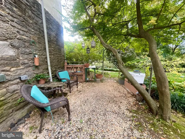 a backyard of a house with outdoor seating