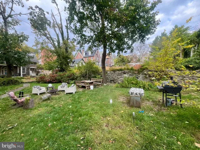 a backyard of a house with table and chairs