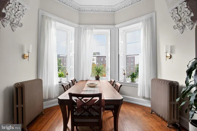 a view of a dining room with furniture window and wooden floor