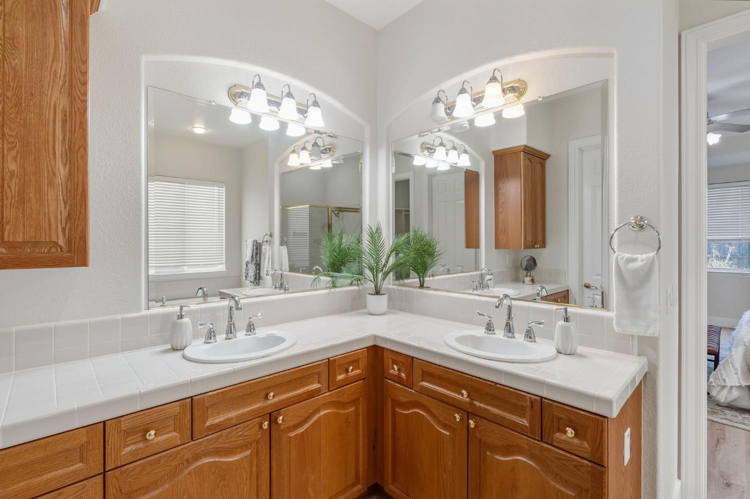 3412 Muscat Way Rancho Cordova, CA 95670 - Photo 21 of 33 a bathroom with double vanity sinks and a mirror