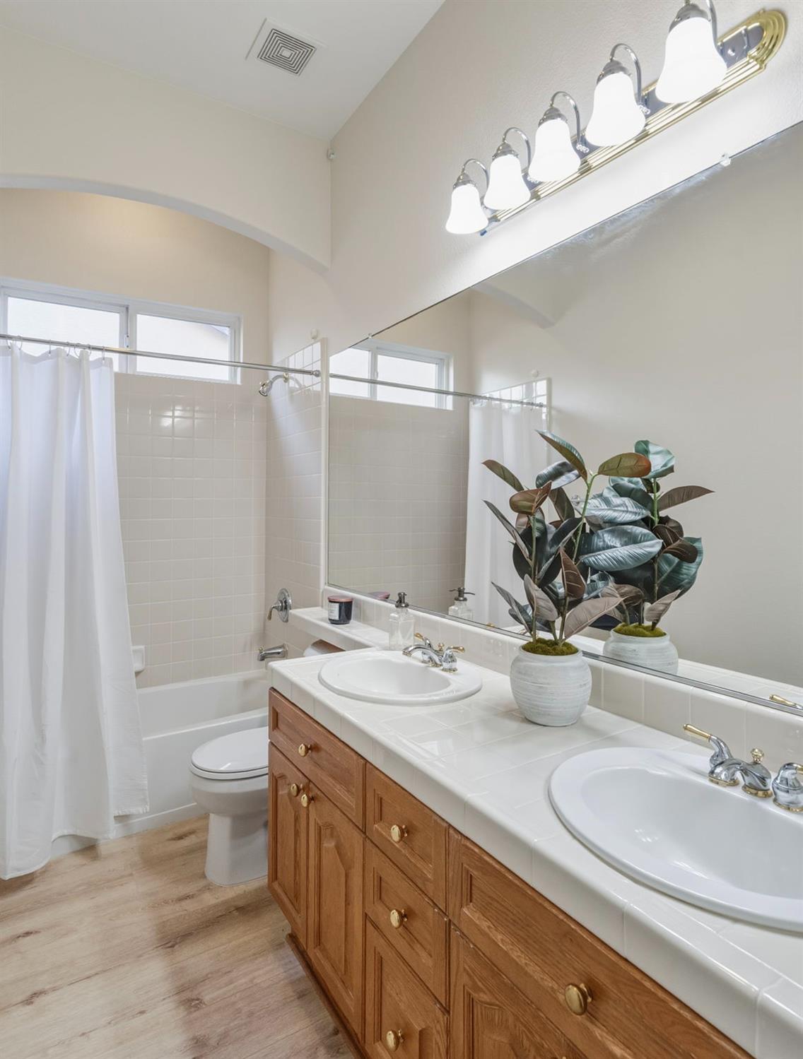 3412 Muscat Way Rancho Cordova, CA 95670 - Photo 27 of 33 a bathroom with a double vanity sink mirror and toilet