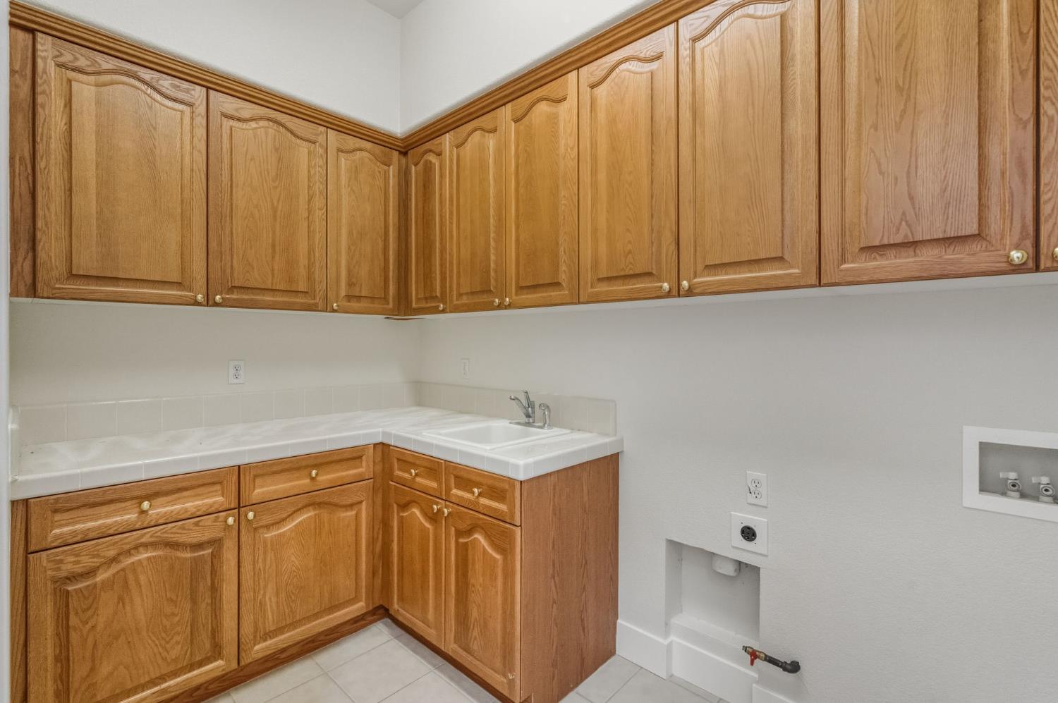 3412 Muscat Way Rancho Cordova, CA 95670 - Photo 29 of 33 a utility room with granite countertop cabinets and sink