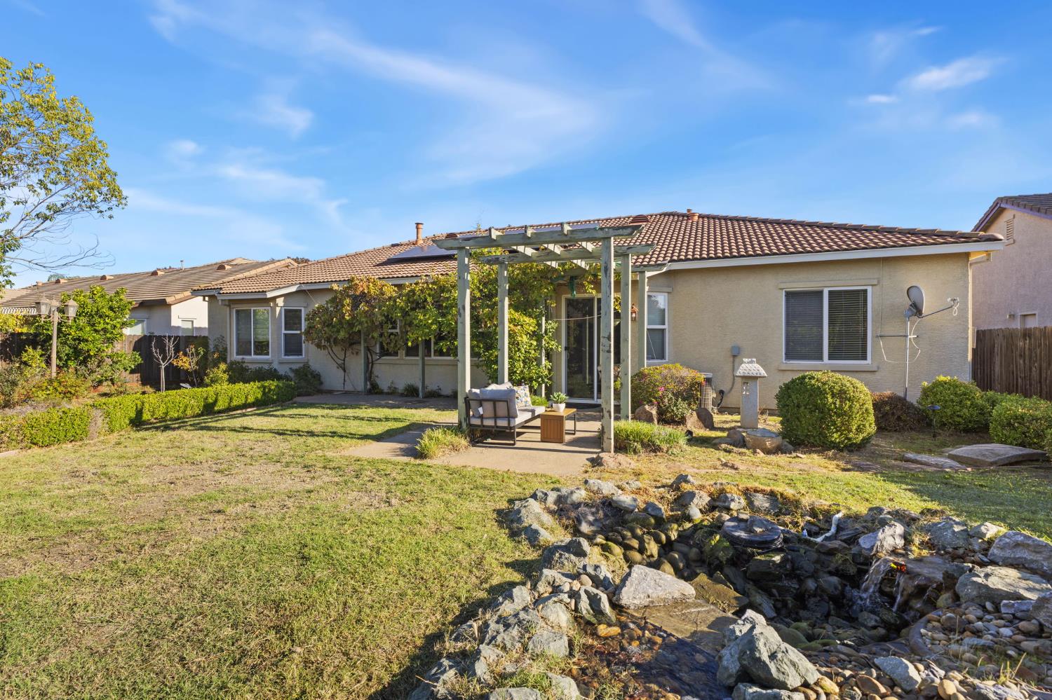 3412 Muscat Way Rancho Cordova, CA 95670 - Photo 30 of 33 a view of a house with backyard porch and furniture