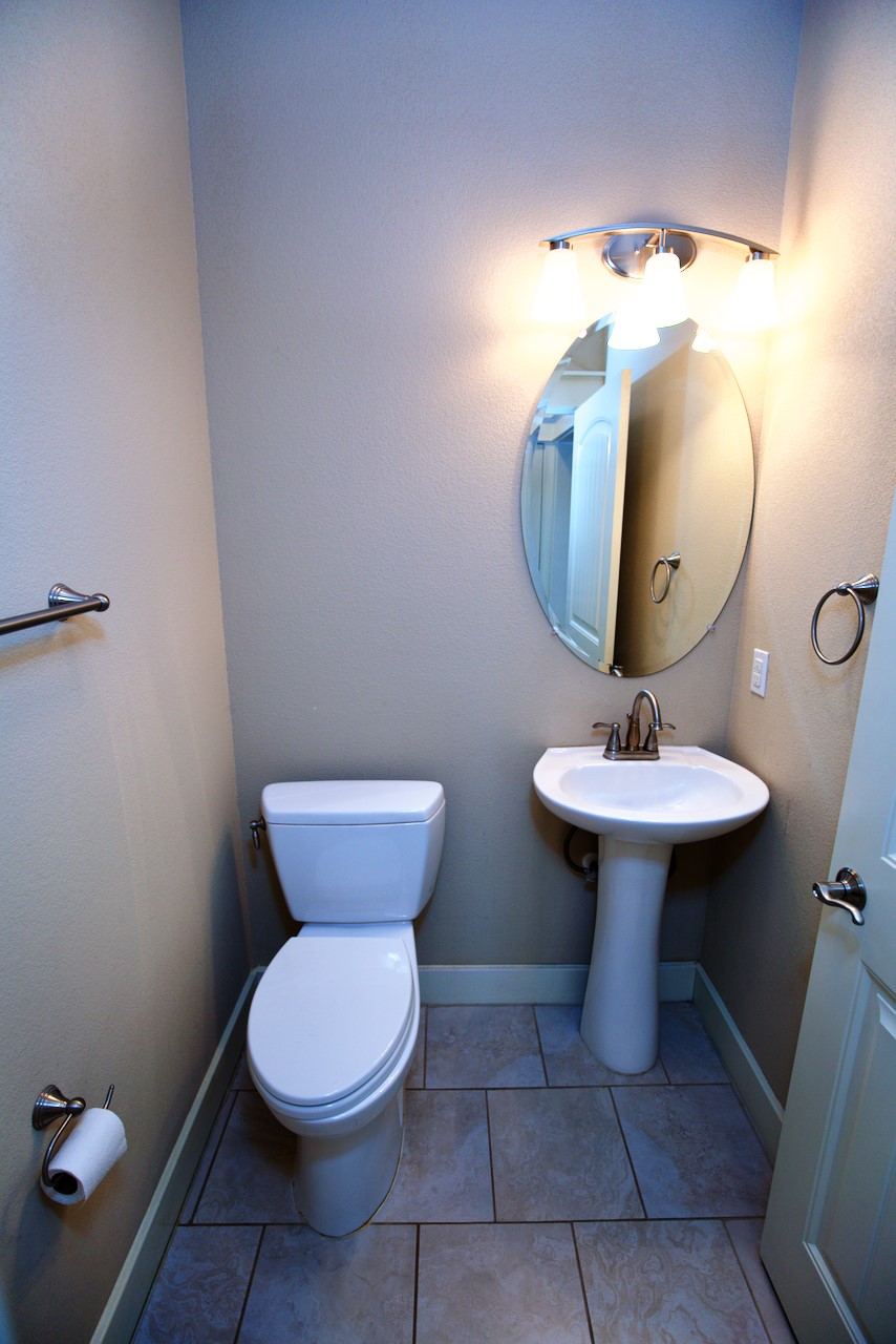 1800 Richcreek Road, Unit B Austin, TX 78757 - Photo 5 of 10 a bathroom with a toilet sink and mirror