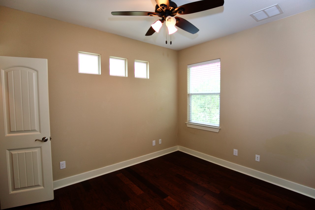 1800 Richcreek Road, Unit B Austin, TX 78757 - Photo 7 of 10 a view of an empty room with wooden floor and a window