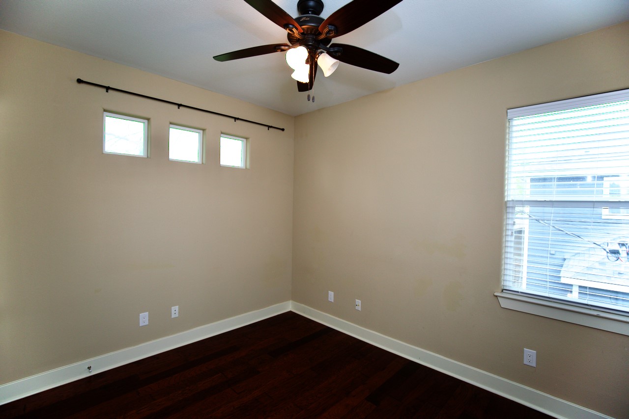 1800 Richcreek Road, Unit B Austin, TX 78757 - Photo 9 of 10 a view of an empty room with wooden floor and a window