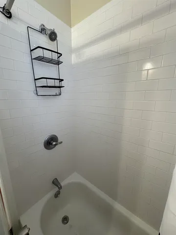 a bathroom with a bathtub and shower