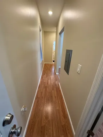 a view of gallery with wooden floor