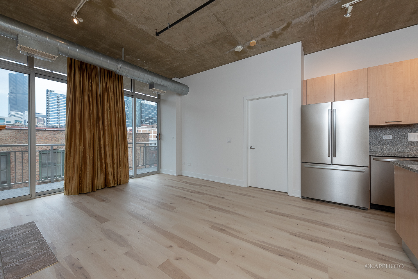111 South Morgan Street, Unit 619 Chicago, IL 60607 - Photo 13 of 35 a view of kitchen with refrigerator and wooden floor
