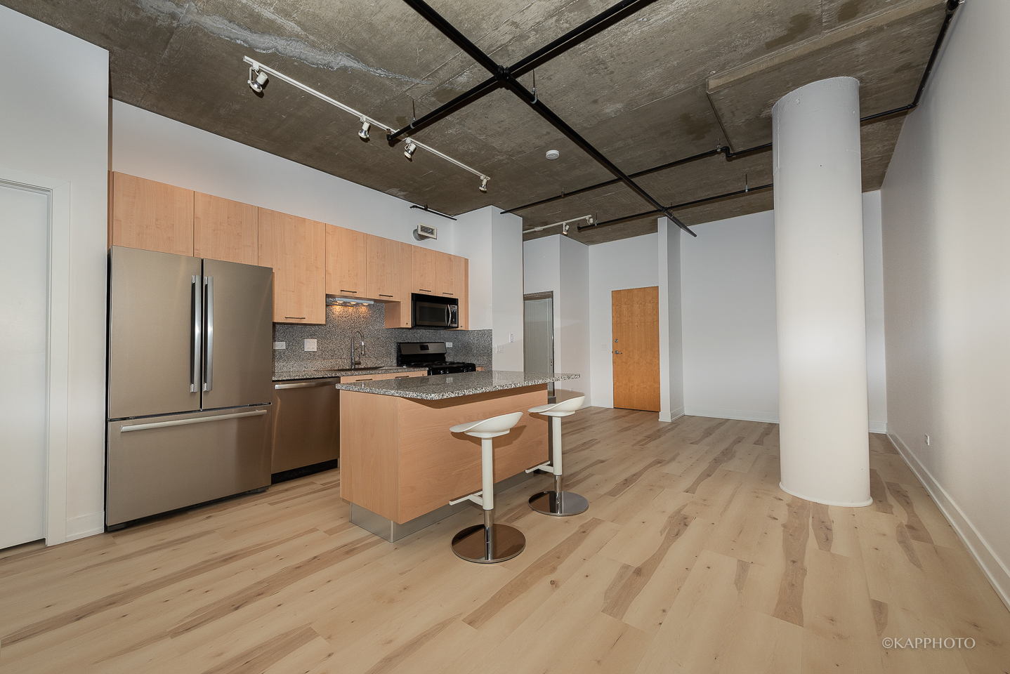 111 South Morgan Street, Unit 619 Chicago, IL 60607 - Photo 14 of 35 a kitchen with a refrigerator and white cabinets