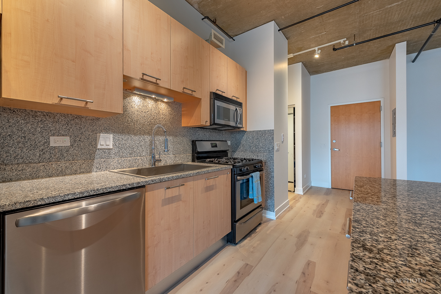 111 South Morgan Street, Unit 619 Chicago, IL 60607 - Photo 15 of 35 a kitchen with stainless steel appliances granite countertop a sink a stove and a refrigerator