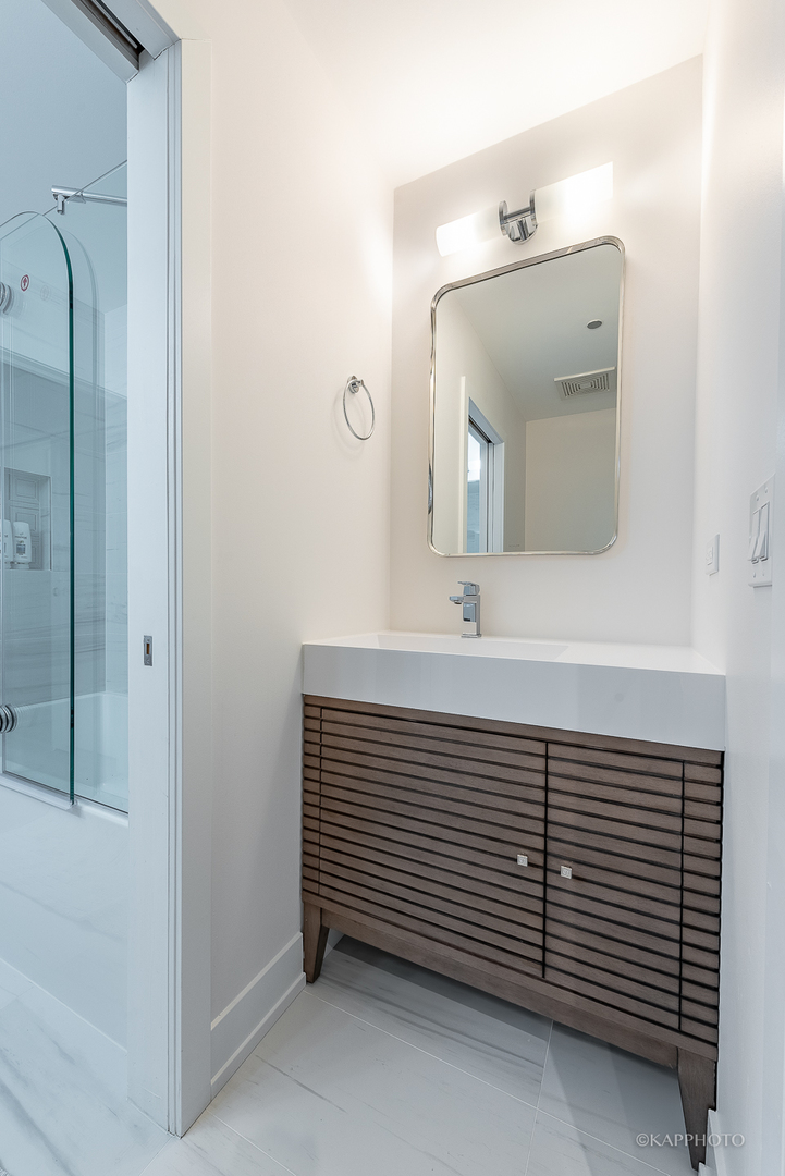 111 South Morgan Street, Unit 619 Chicago, IL 60607 - Photo 28 of 35 a bathroom with a sink and a mirror