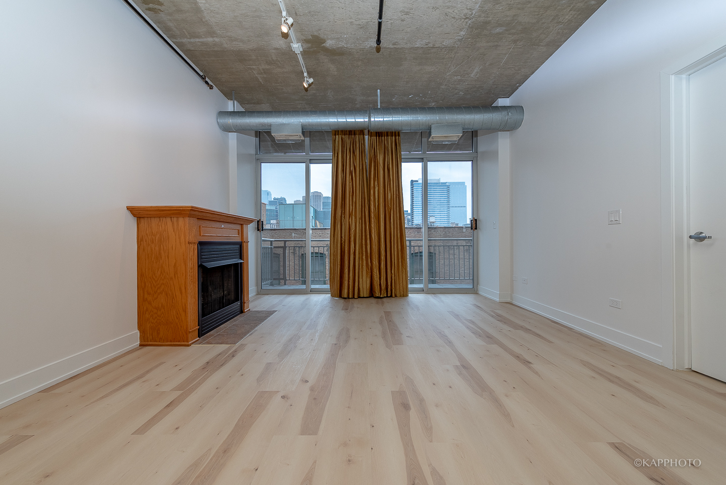 111 South Morgan Street, Unit 619 Chicago, IL 60607 - Photo 10 of 35 wooden floor in an empty room with a fireplace
