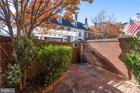 a pathway of a house with a tree