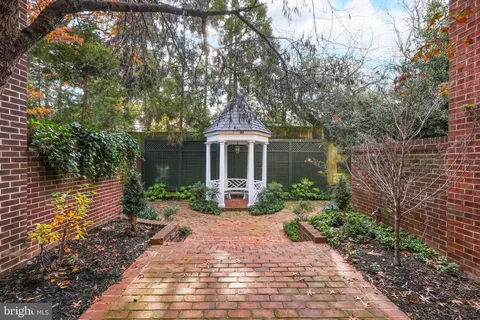 a front view of a house with garden and porch
