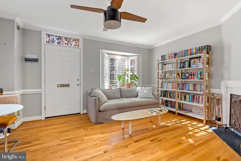 a living room with furniture and a book shelf